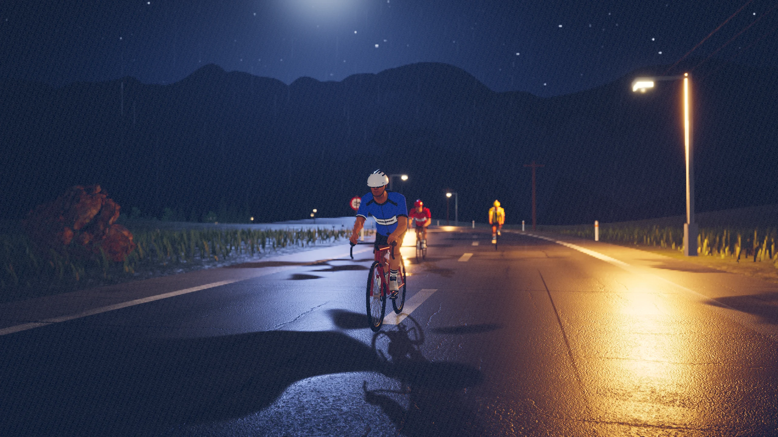 Cyclist seen from the front with orange reflections on the asphalt